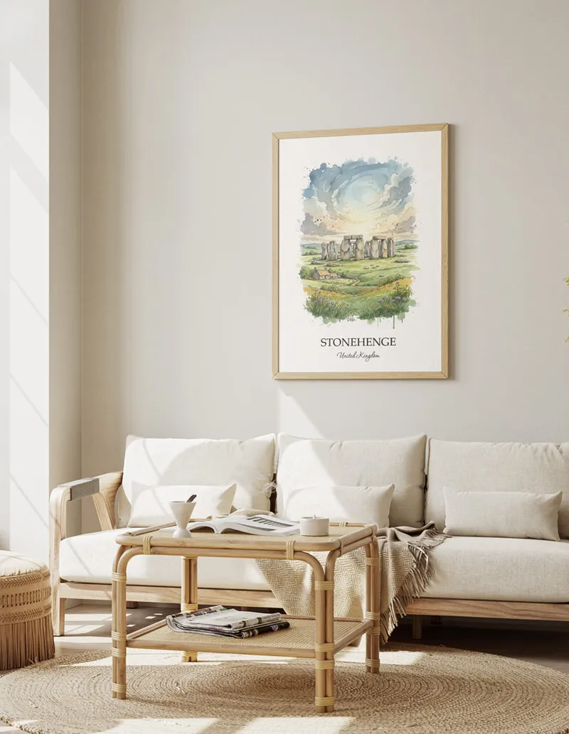 Framed wall art featuring Stonehenge, United Kingdom in a light wood frame hanging above a sofa in a modern living room.