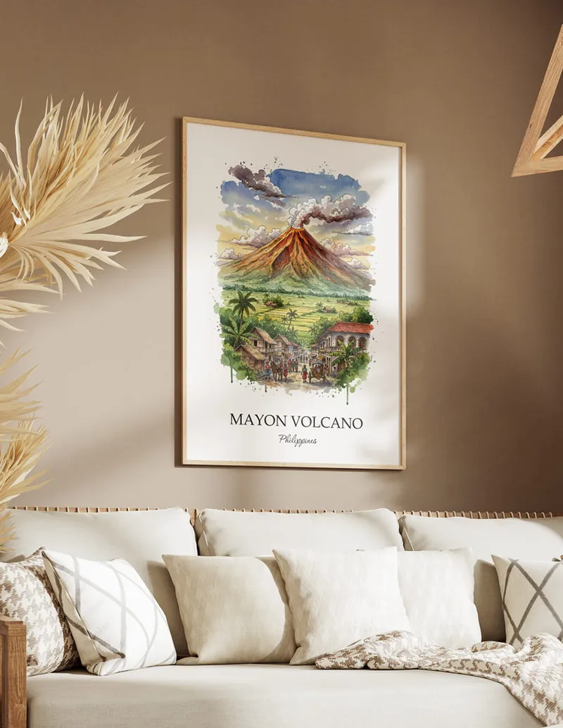 Framed wall art featuring Mayon Volcano, Philippines in a light wood frame hanging above a sofa in a modern living room.