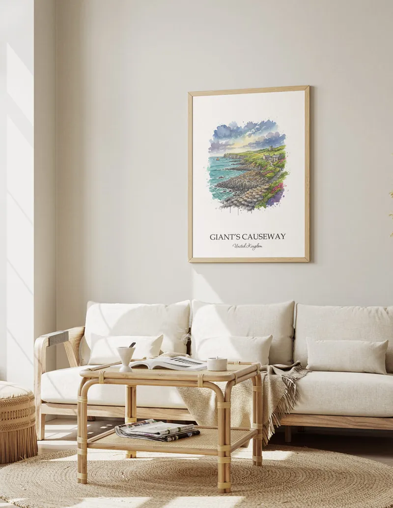 Framed wall art featuring Giant's Causeway, United Kingdom in a light wood frame hanging above a sofa in a modern living room.