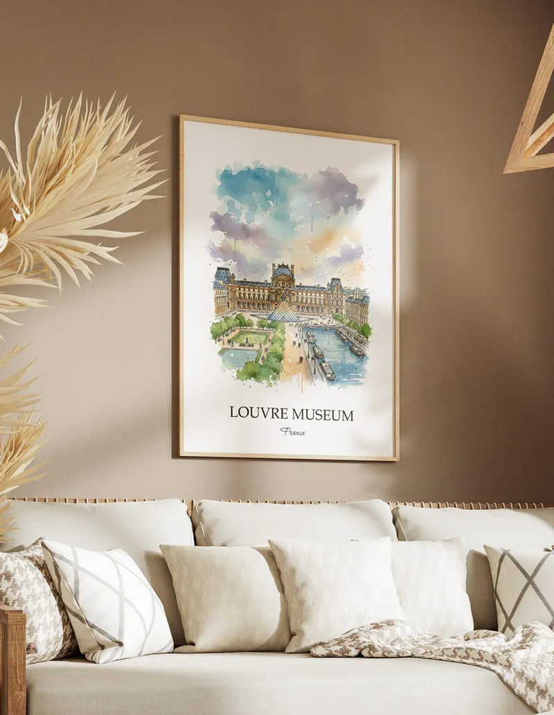 Vintage travel poster of Louvre Museum, France in a light frame displayed above a sofa in a bright boho interior.
