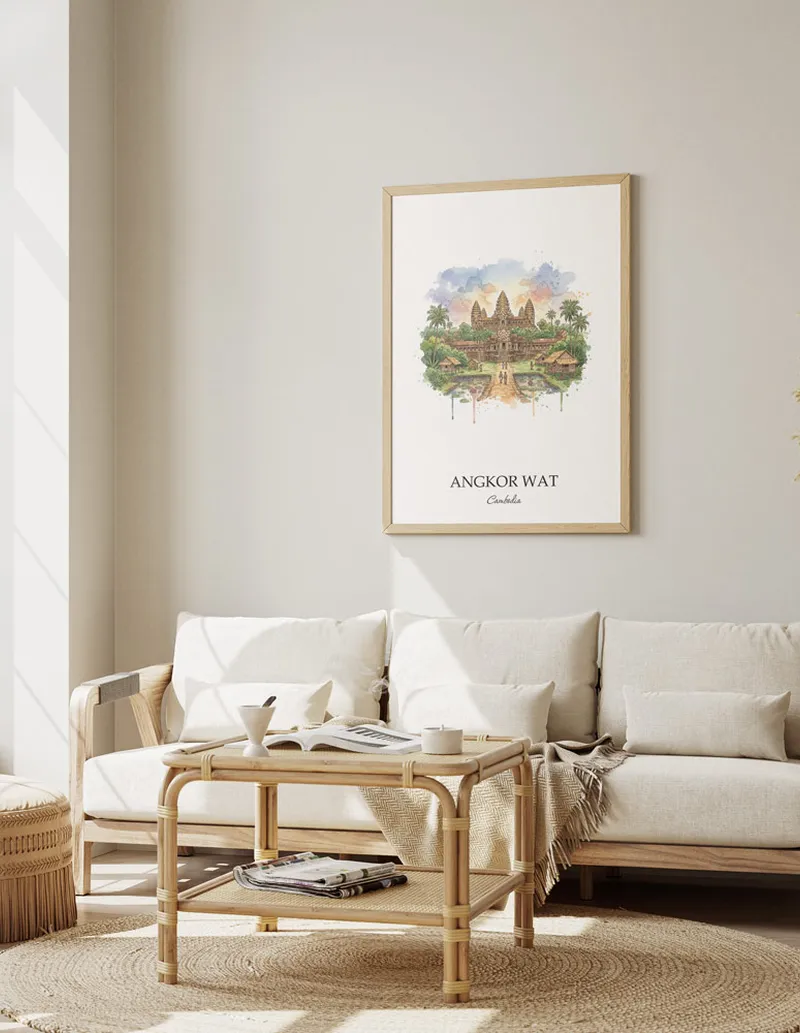 Framed wall art featuring Angkor Wat, Cambodia in a light wood frame hanging above a sofa in a modern living room.
