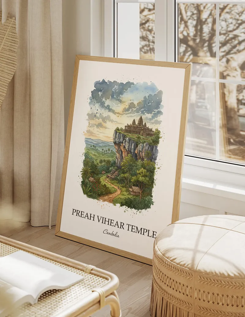 Framed wall art featuring Preah Vihear Temple, Cambodia in a light wood frame hanging above a sofa in a modern living room.