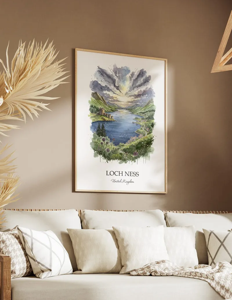 Vintage travel poster of Loch Ness, United Kingdom in a light frame displayed above a sofa in a bright boho interior.
