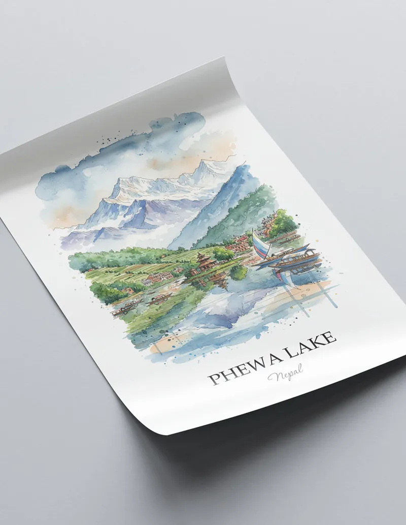 Framed wall art featuring Phewa Lake in Nepal in a light wood frame leaning on the floor.