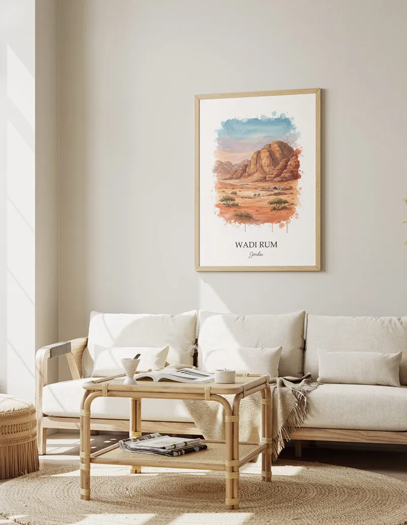 Vintage travel poster of Wadi Rum, Jordan in a light frame displayed above a sofa in a bright boho interior.
