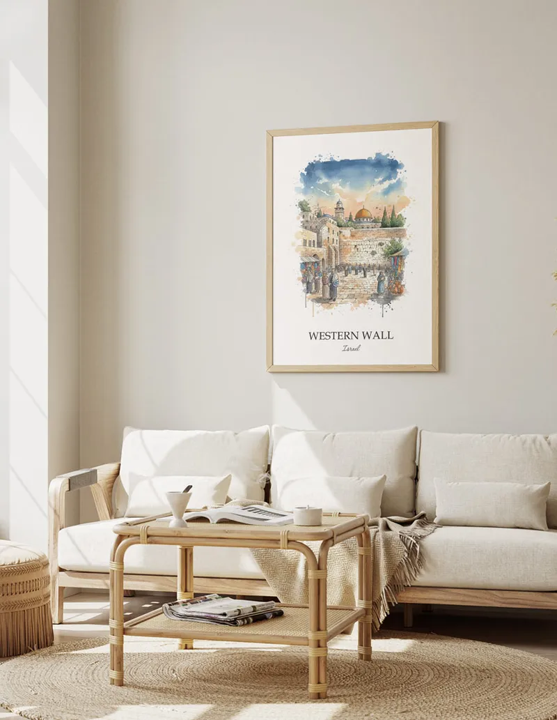 Vintage travel poster of Western Wall, Israel in a light frame displayed above a sofa in a bright boho interior.