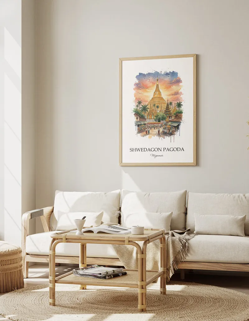 Vintage travel poster of Shwedagon Pagoda, Myanmar in a light frame displayed above a sofa in a bright boho interior.