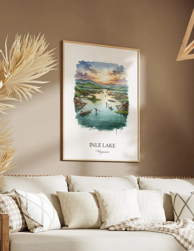 A gorgeous boho-inspired living space with a framed vintage travel poster of Inle Lake in Myanmar on display.
