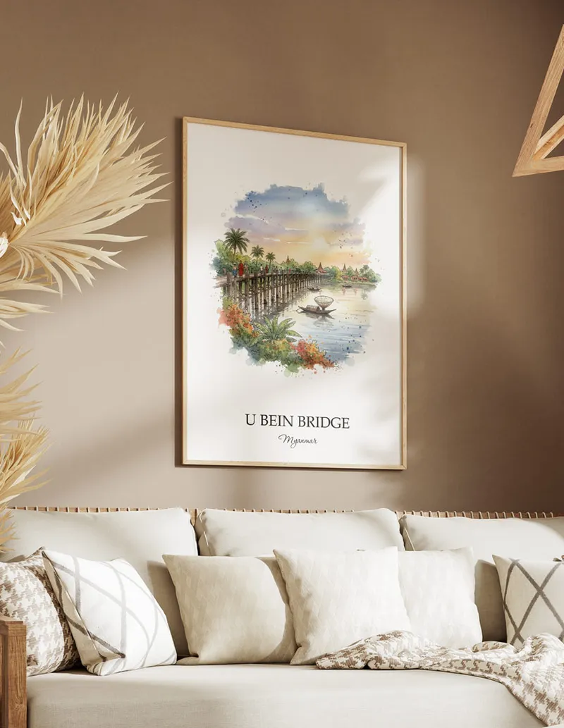 A gorgeous boho-inspired living space with a framed vintage travel poster of U Bein Bridge in Myanmar on display.