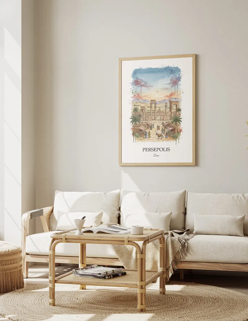 Vintage travel poster of Persepolis, Iran in a light frame displayed above a sofa in a bright boho interior.