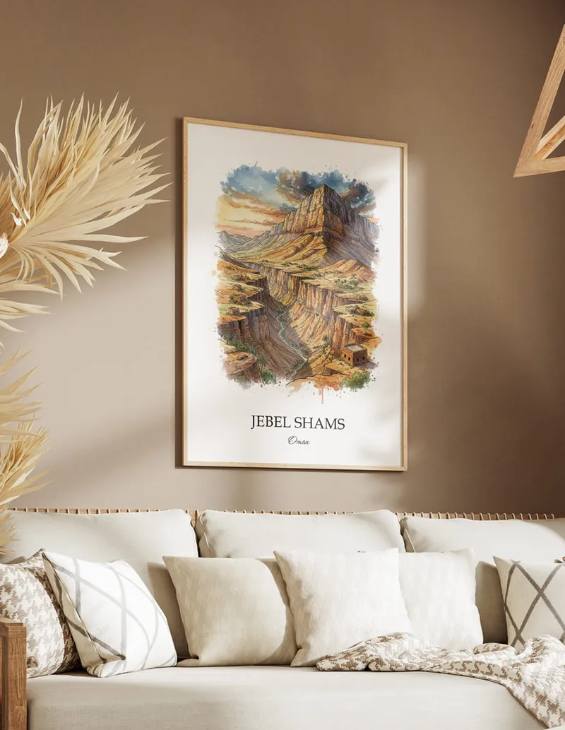 A gorgeous boho-inspired living space with a framed vintage travel poster of Jebel Shams in Oman on display.