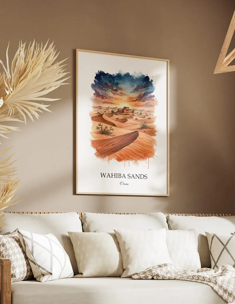 A gorgeous boho-inspired living space with a framed vintage travel poster of Wahiba Sands in Oman on display.