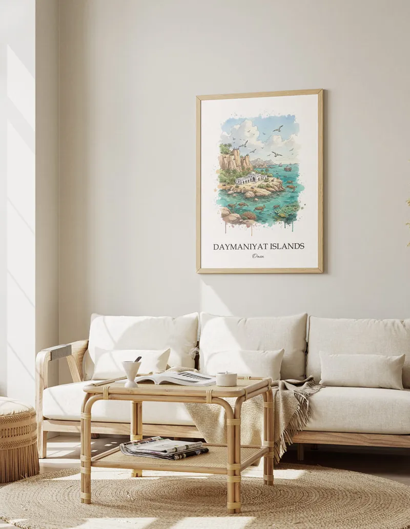 Vintage travel poster of Daymaniyat Islands, Oman in a light frame displayed above a sofa in a bright boho interior.