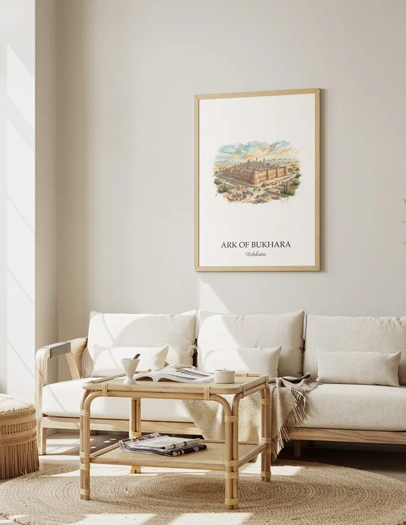 Vintage travel poster of Ark of Bukhara, Uzbekistan in a light frame displayed above a sofa in a bright boho interior.