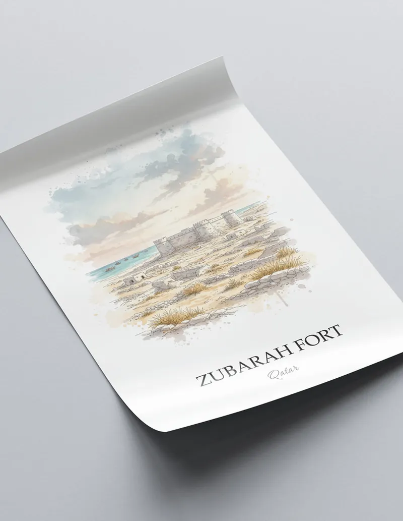 Framed wall art featuring Zubarah Fort in Qatar in a light wood frame leaning on the floor.