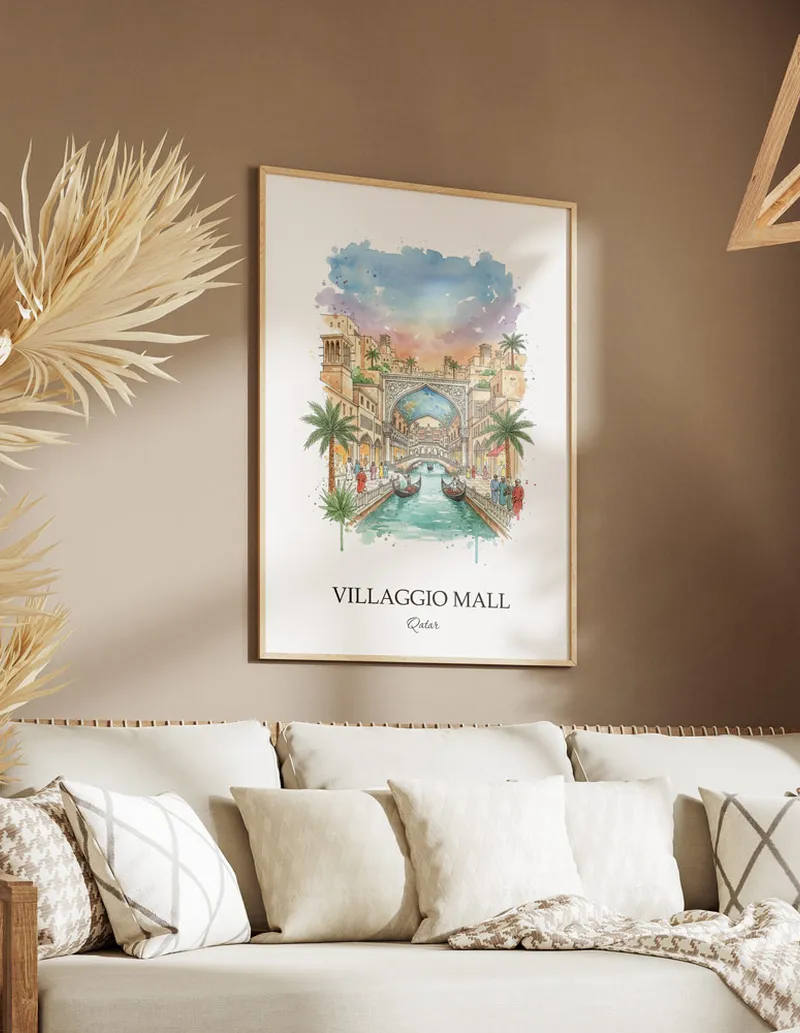 A gorgeous boho-inspired living space with a framed vintage travel poster of Villaggio Mall in Qatar on display.