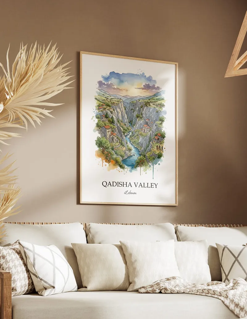 A gorgeous boho-inspired living space with a framed vintage travel poster of Qadisha Valley in Lebanon on display.