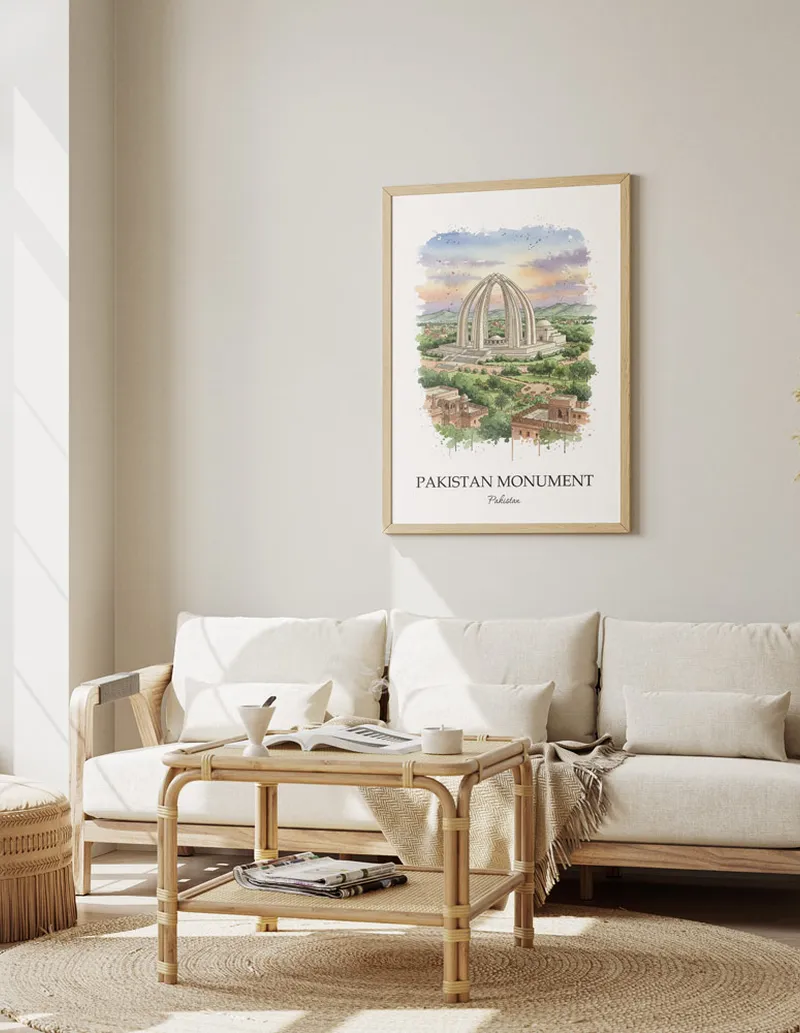 Vintage travel poster of Pakistan Monument, Pakistan in a light frame displayed above a sofa in a bright boho interior.