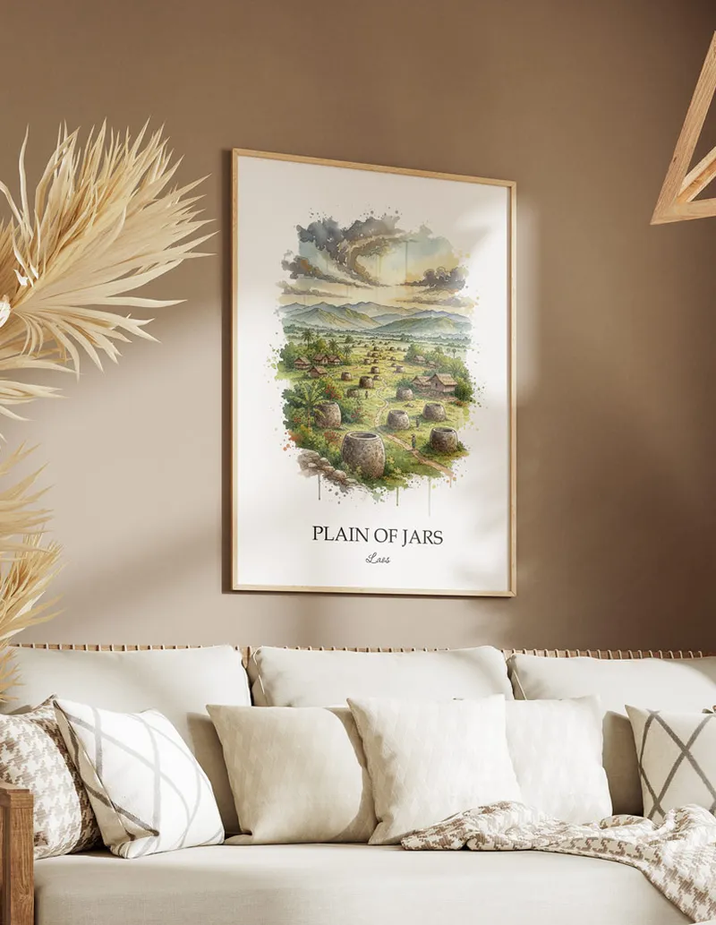 Cozy, well-lit workspace with a minimalist poster of Plain of Jars, Laos in a light frame sitting on the desk.