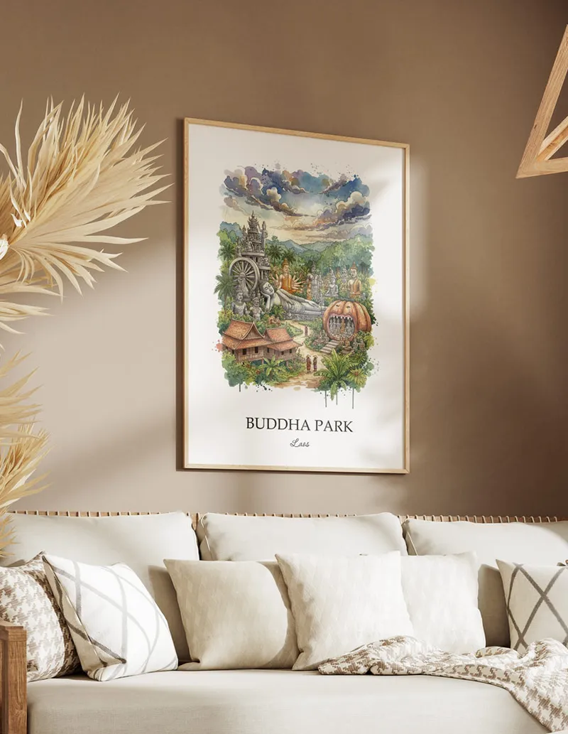 Cozy, well-lit workspace with a minimalist poster of Buddha Park, Laos in a light frame sitting on the desk.