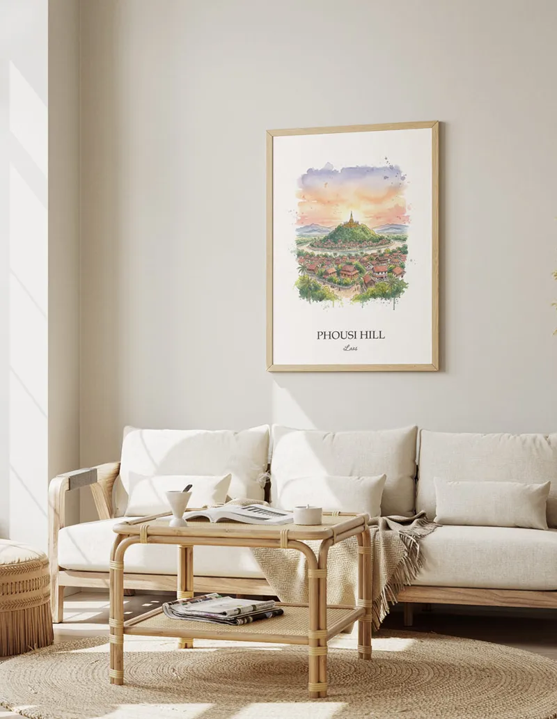 A gorgeous boho-inspired living space with a framed vintage travel poster of Phousi Hill in Laos on display.