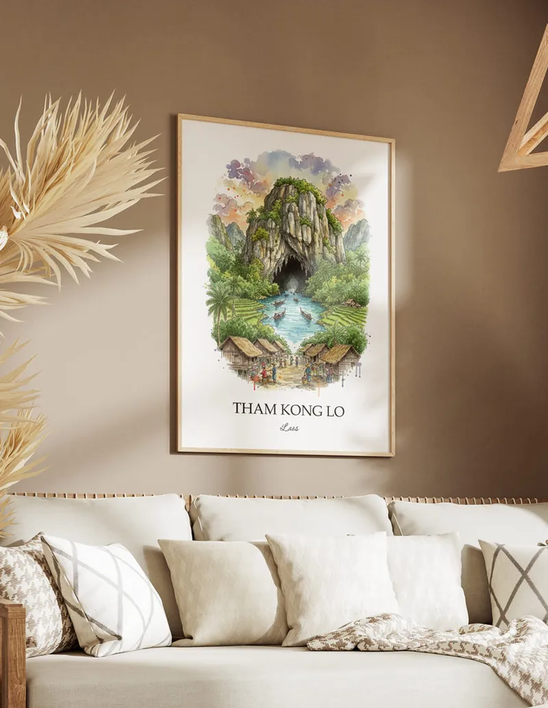 Cozy, well-lit workspace with a minimalist poster of Tham Kong Lo, Laos in a light frame sitting on the desk.