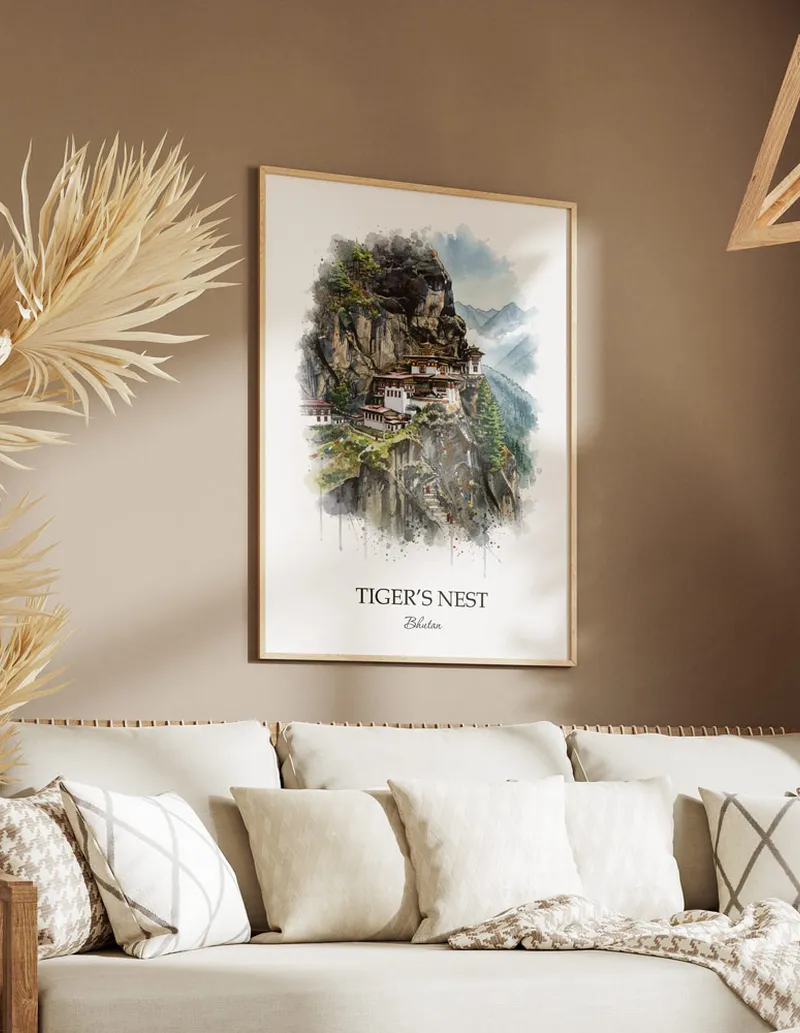 Cozy, well-lit workspace with a minimalist poster of Tiger's Nest, Bhutan in a light frame sitting on the desk.