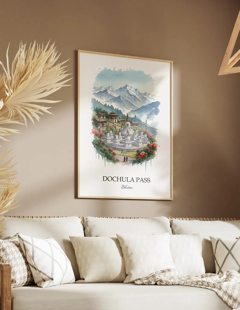 Cozy, well-lit workspace with a minimalist poster of Dochula Pass, Bhutan in a light frame sitting on the desk.