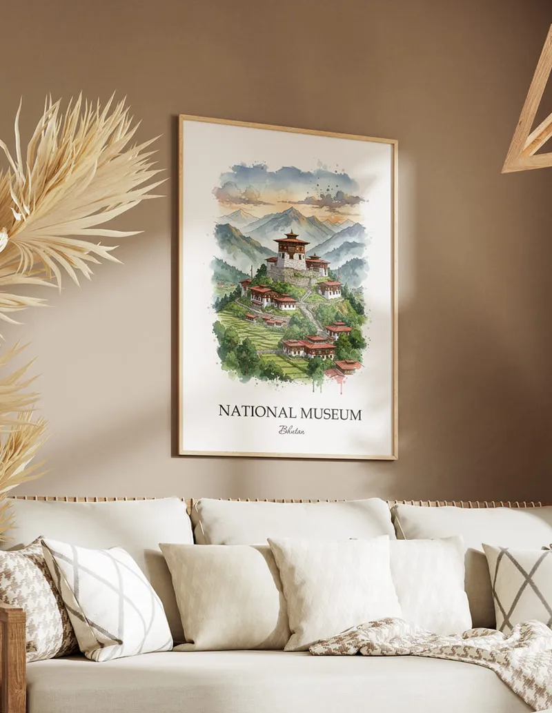 Cozy, well-lit workspace with a minimalist poster of National Museum, Bhutan in a light frame sitting on the desk.