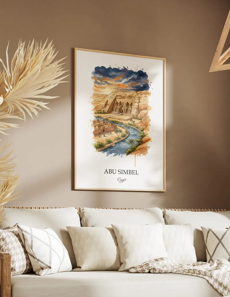 Cozy, well-lit workspace with a minimalist poster of Abu Simbel, Egypt in a light frame sitting on the desk.