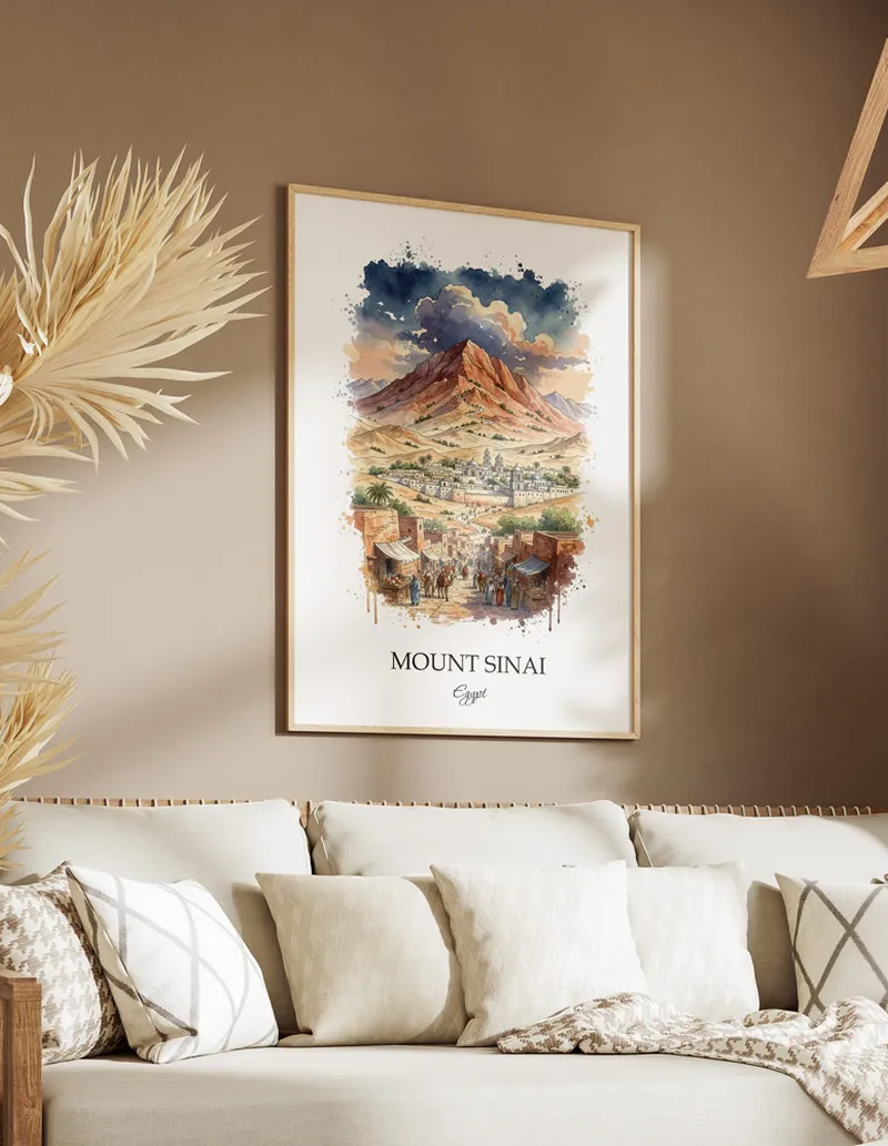 Cozy, well-lit workspace with a minimalist poster of Mount Sinai, Egypt in a light frame sitting on the desk.