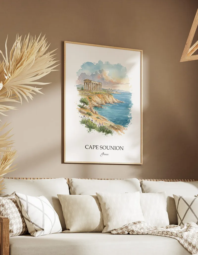 Vintage travel poster of Cape Sounion, Greece in a light frame displayed above a sofa in a bright boho interior.