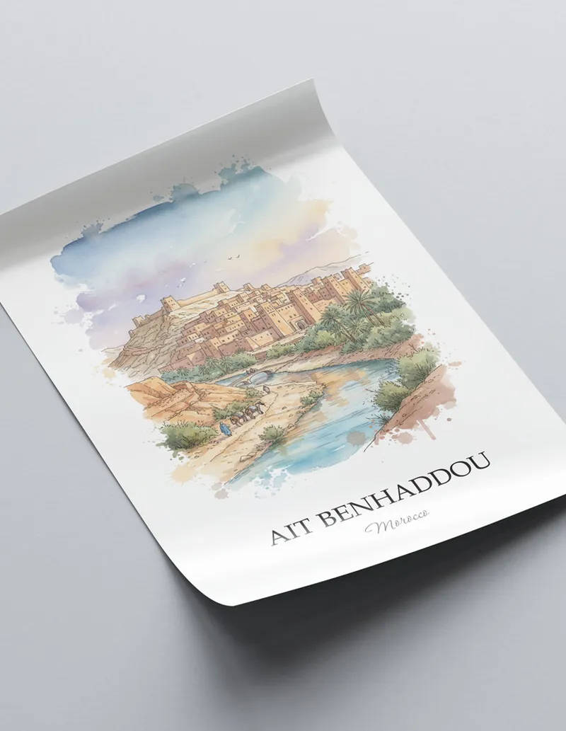 Minimalist poster of Ait Benhaddou in Morocco in a light frame standing on the floor in a dark moody interior.