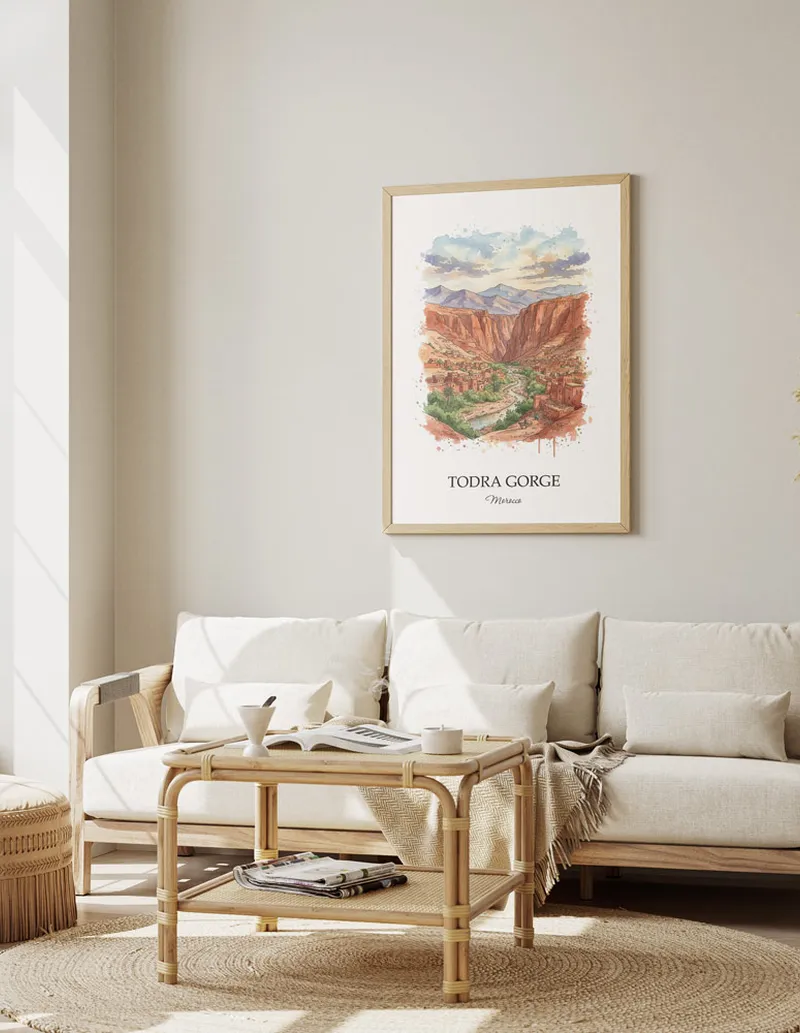 A gorgeous boho-inspired living space with a framed vintage travel poster of Todra Gorge in Morocco on display.