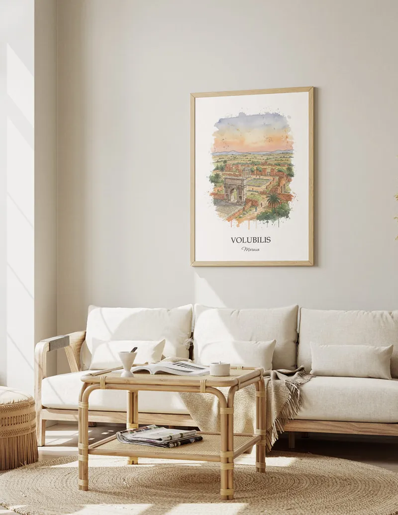 A gorgeous boho-inspired living space with a framed vintage travel poster of Volubilis in Morocco on display.