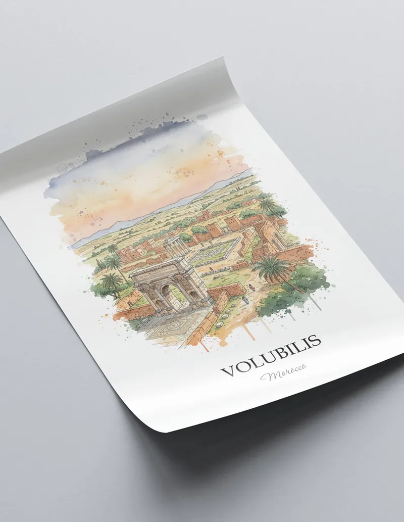 Minimalist poster of Volubilis in Morocco in a light frame standing on the floor in a dark moody interior.