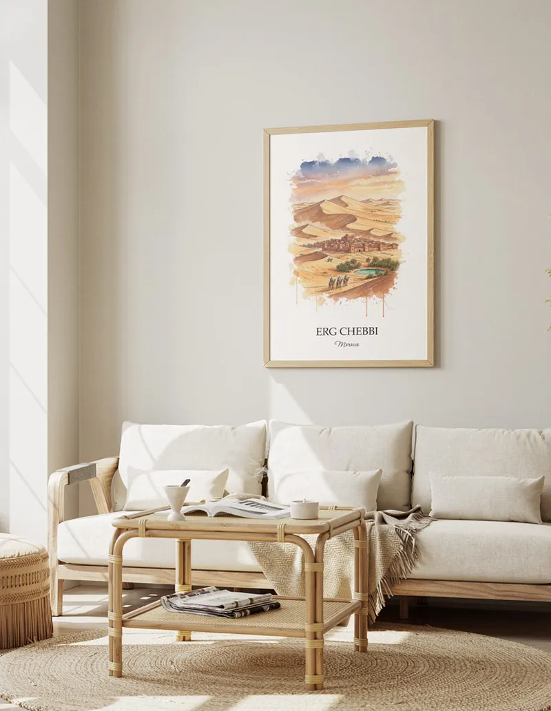 A gorgeous boho-inspired living space with a framed vintage travel poster of Erg Chebbi in Morocco on display.