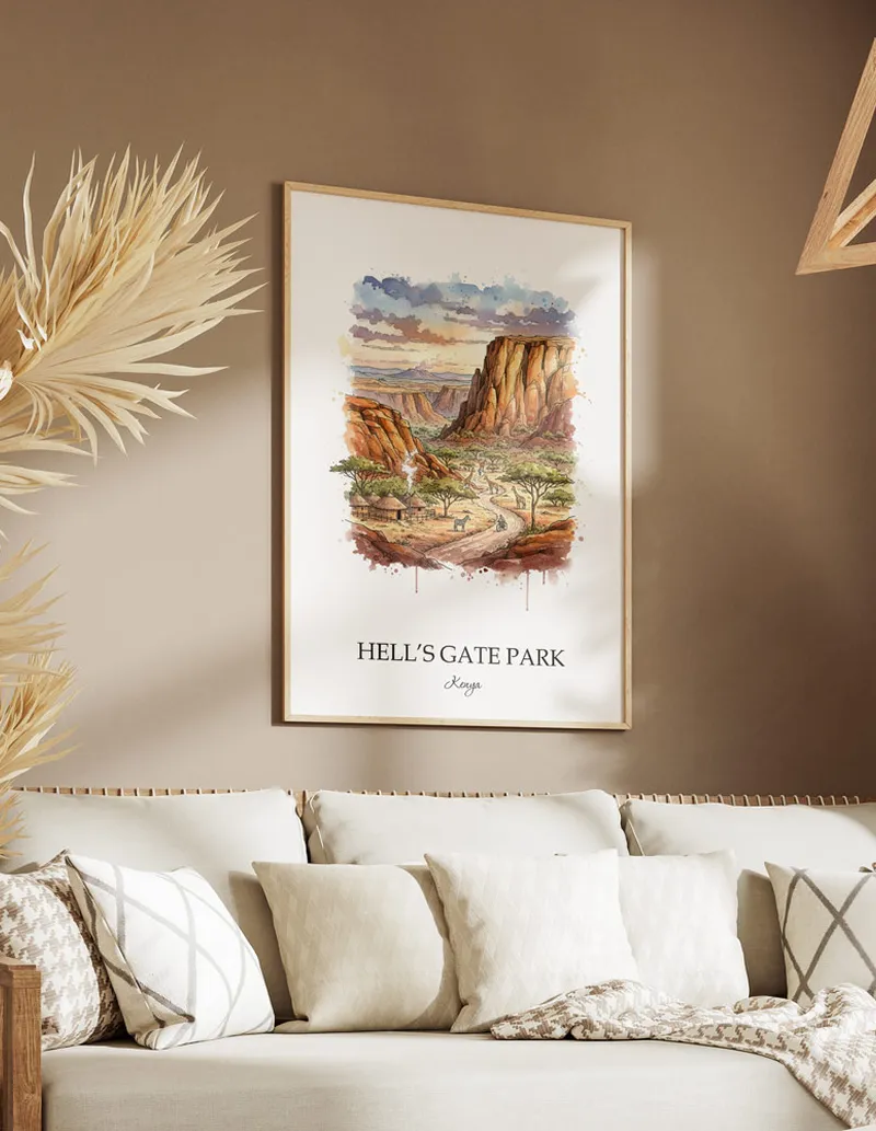 Cozy, well-lit workspace with a minimalist poster of Hell's Gate Park, Kenya in a light frame sitting on the desk.