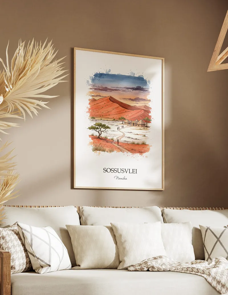 Cozy, well-lit workspace with a minimalist poster of Sossusvlei, Namibia in a light frame sitting on the desk.