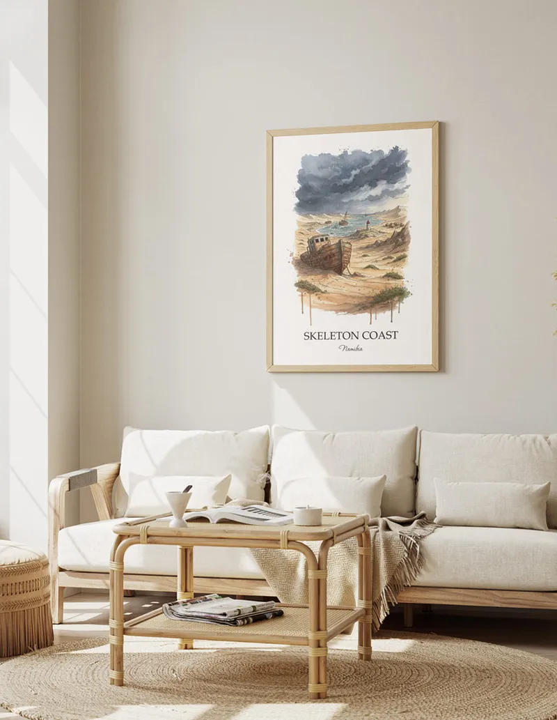 A gorgeous boho-inspired living space with a framed vintage travel poster of Skeleton Coast in Namibia on display.