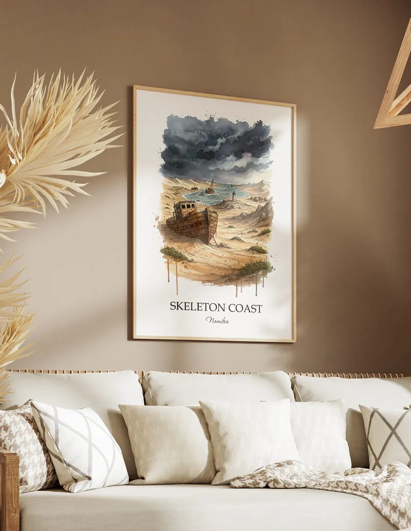 Cozy, well-lit workspace with a minimalist poster of Skeleton Coast, Namibia in a light frame sitting on the desk.