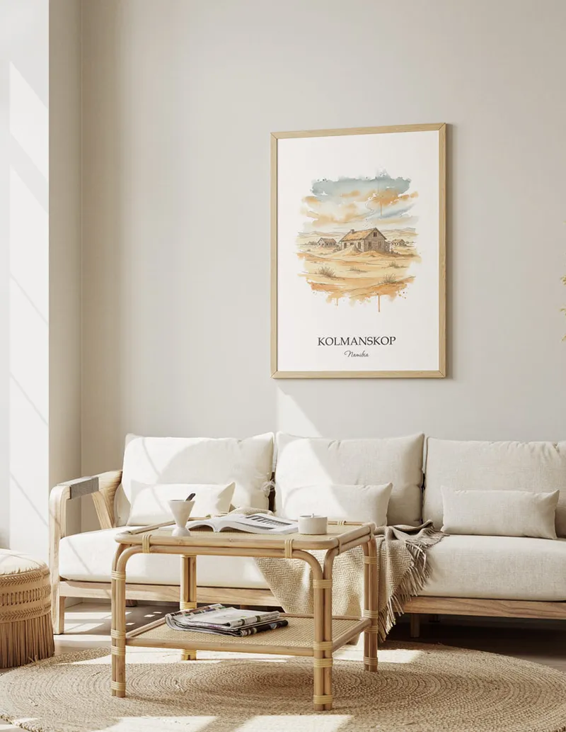 A gorgeous boho-inspired living space with a framed vintage travel poster of Kolmanskop in Namibia on display.