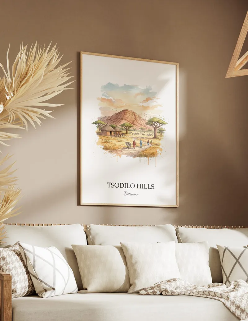Cozy, well-lit workspace with a minimalist poster of Tsodilo Hills, Botswana in a light frame sitting on the desk.