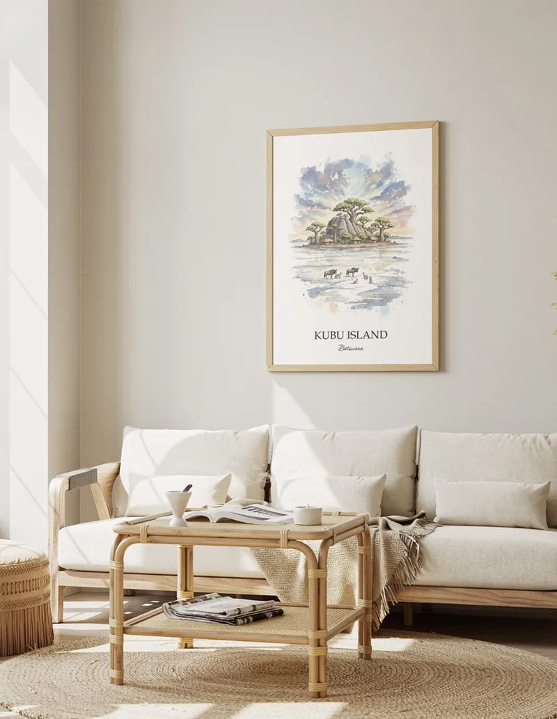 Cozy, well-lit workspace with a minimalist poster of Kubu Island, Botswana in a light frame sitting on the desk.