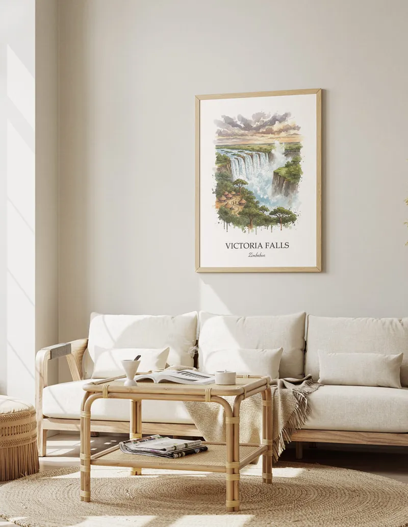 Cozy, well-lit workspace with a minimalist poster of Victoria Falls, Zimbabwe in a light frame sitting on the desk.