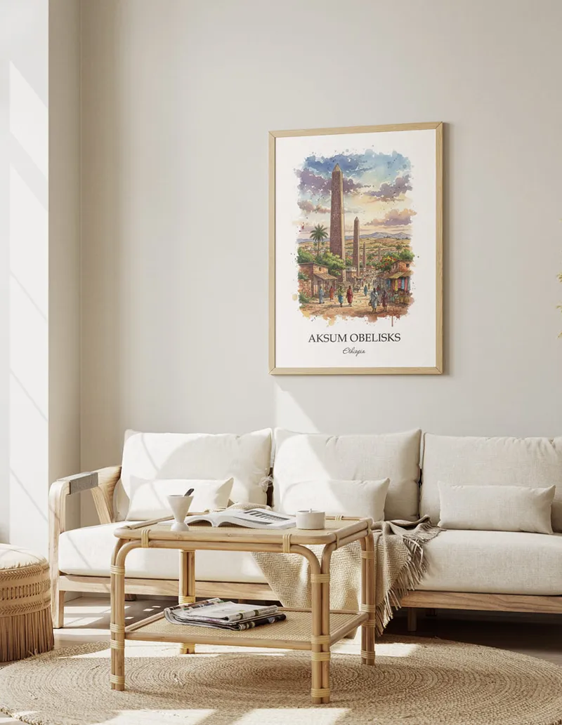 Cozy, well-lit workspace with a minimalist poster of Aksum Obelisks, Ethiopia in a light frame sitting on the desk.