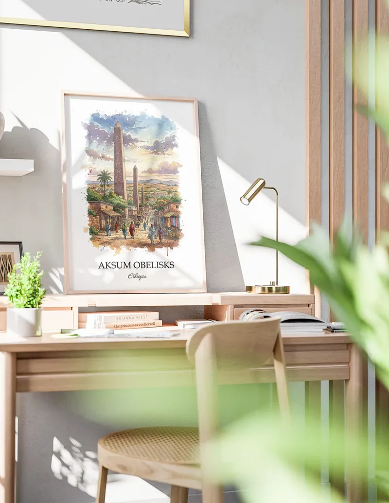 Framed wall art featuring Aksum Obelisks in Ethiopia in a light wood frame leaning on the floor.