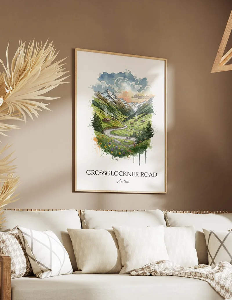 Vintage travel poster of Grossglockner Road, Austria in a light frame displayed above a sofa in a bright boho interior.