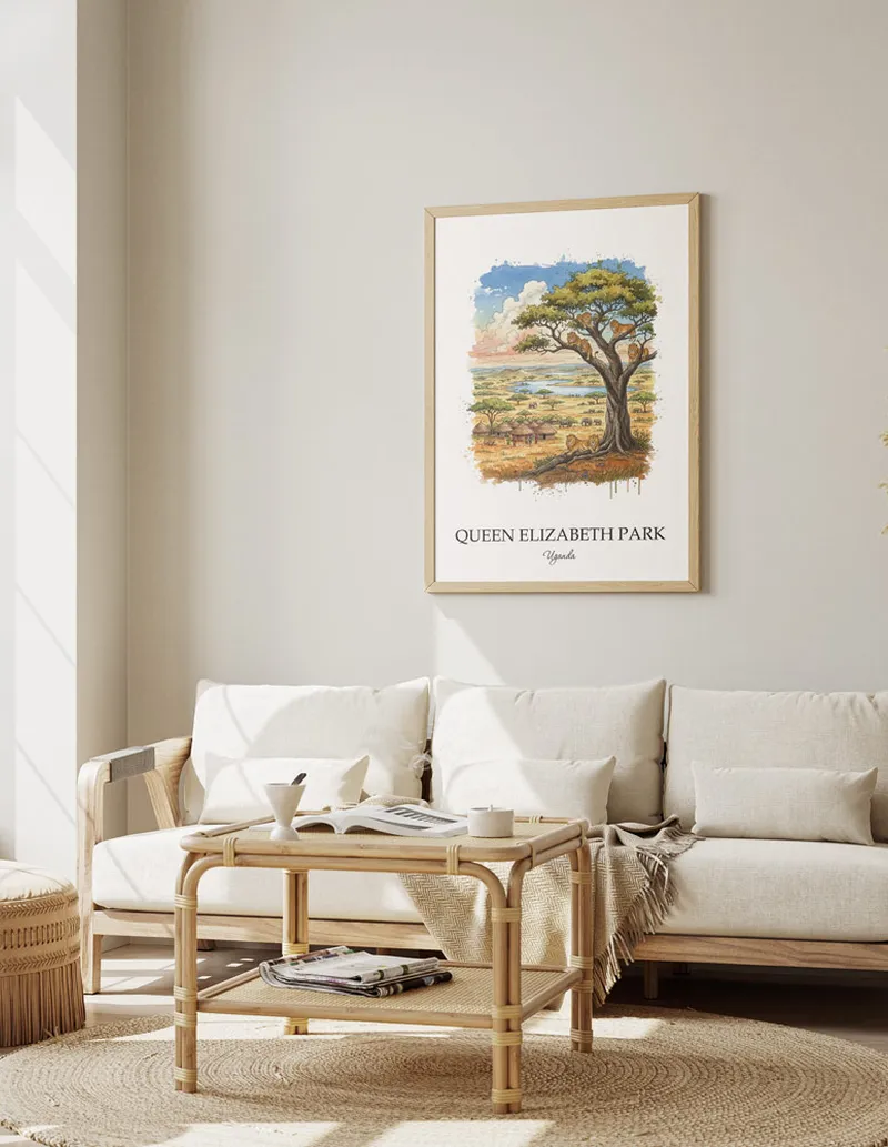 Cozy, well-lit workspace with a minimalist poster of Queen Elizabeth Park, Uganda in a light frame sitting on the desk.