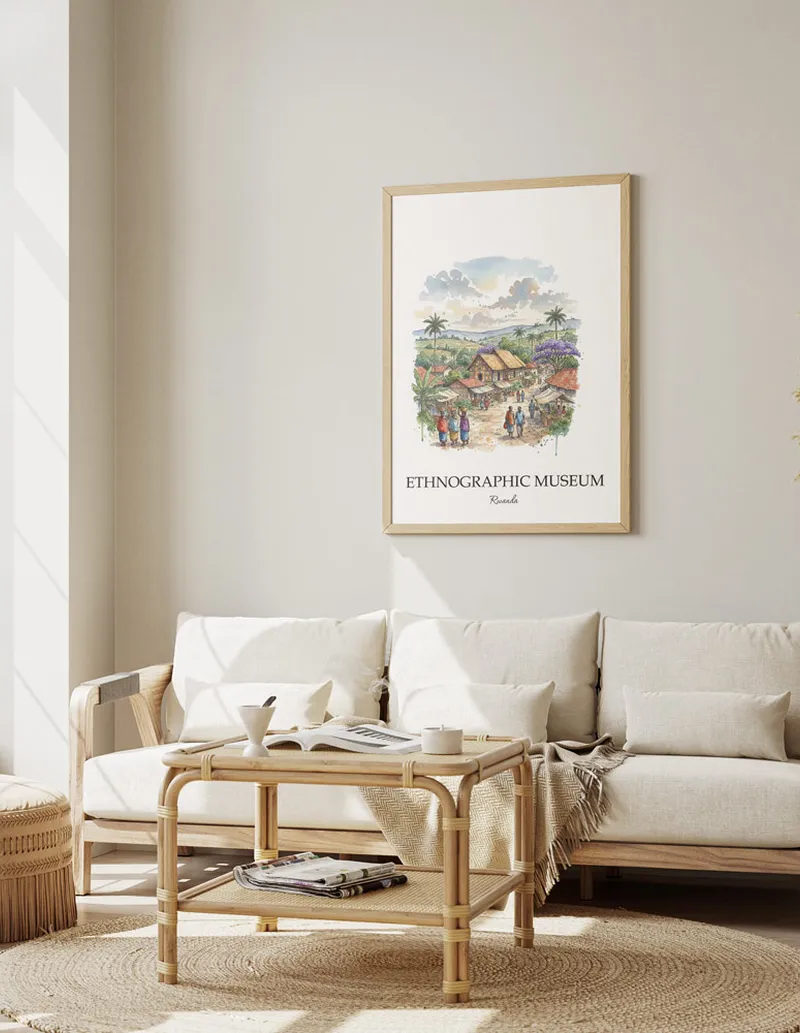 Cozy, well-lit workspace with a minimalist poster of Ethnographic Museum, Rwanda in a light frame sitting on the desk.